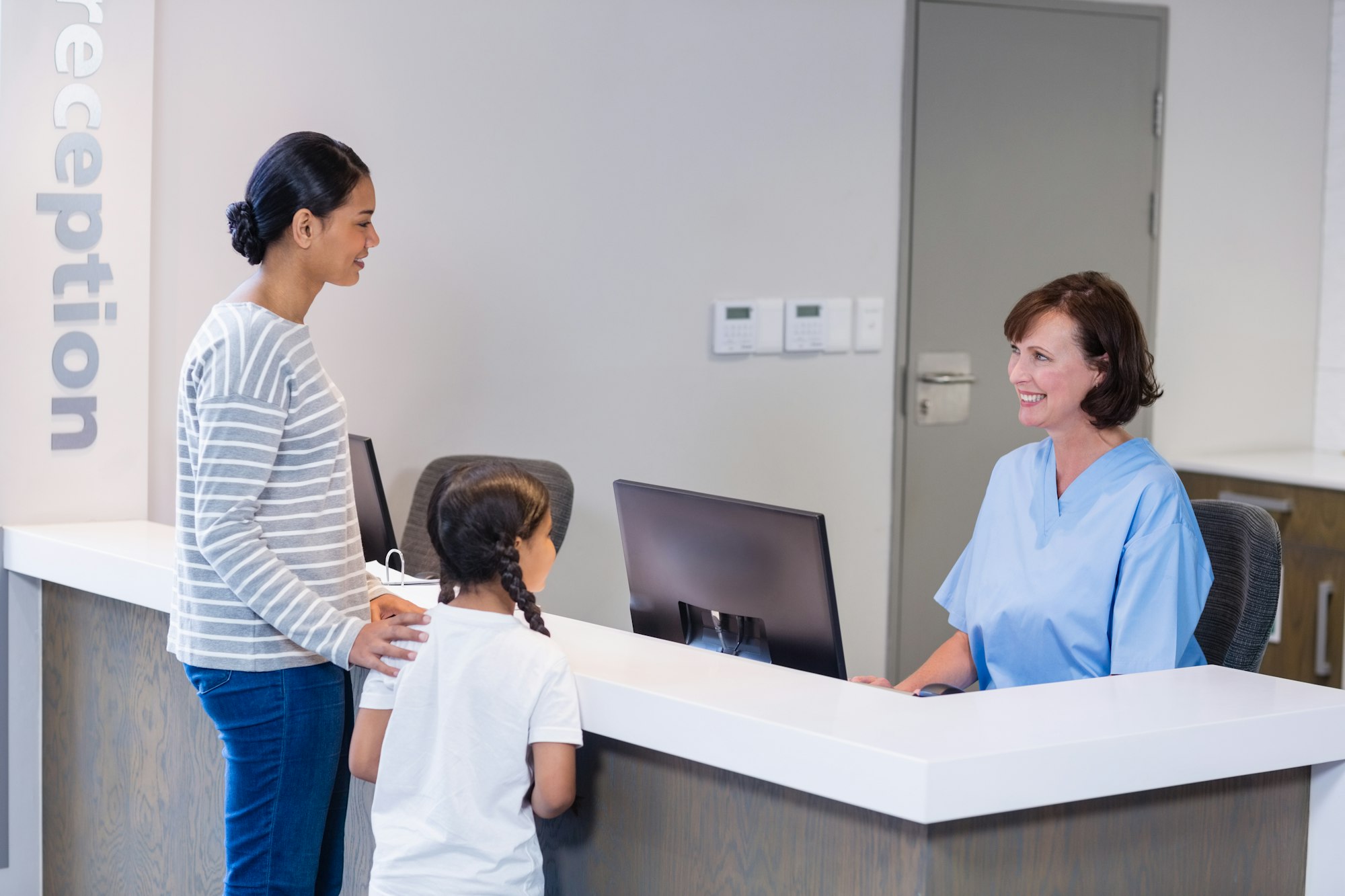 Nurse talking with a patient at counter